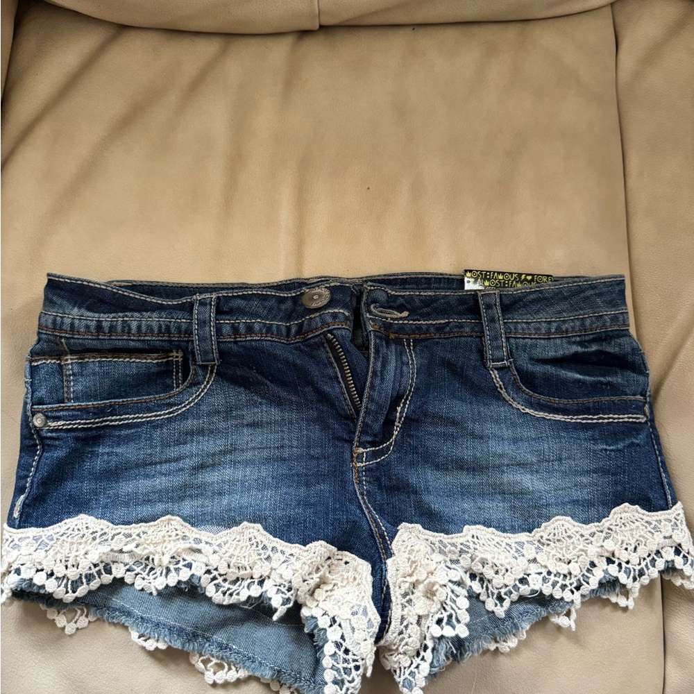 New with tags. Almost Famous Blue Jean Shorts with White Lace Trim Size 5